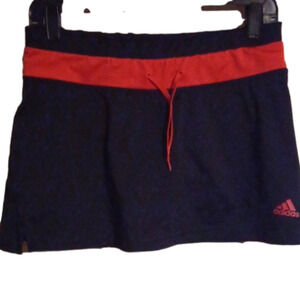 Adidas orange/ black skirt with shorts under.( skort). Super sporty ! Size med